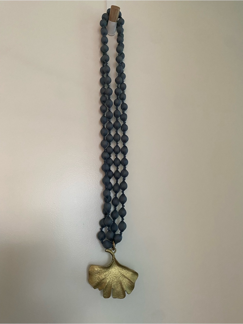 Brass tone Ginkgo Leaf Pendant Necklace with Matte Dark Gray Fabric Beads